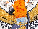 a close up of an orange and black scarf on a table