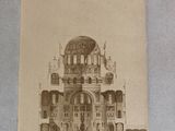 an old photo of a building with a clock on it