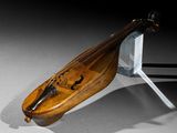 a wooden instrument that is sitting on a stand