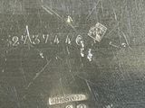 a close up of a silver plate with numbers on it