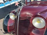 a close up of a red car with a star on the front