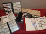 a lot of stamps on a table with a red table cloth