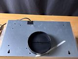 an image of a metal device on a wooden table