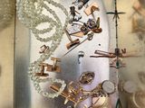 a silver box with a bunch of jewelry inside of it