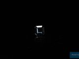 an image of a diamond in the dark on a black surface
