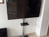 a flat screen tv sitting on a stand in a room