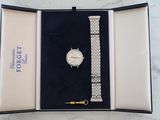 an image of a watch in a box on a marble surface