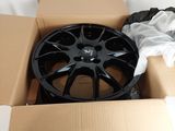a black rim in a box with a white cloth on it