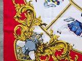 an image of a red and white scarf with a picture of a horse and rider