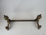 an antique cast iron and brass table with two legs and a handle