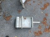 a small metal object on the ground next to a person ' s feet
