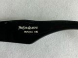 a close up of a pair of black sunglasses on a white surface