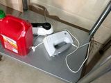 a red can and a green can sitting on a metal shelf