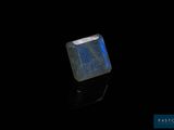 a close up of a blue stone on a black surface