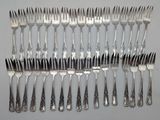 a lot of forks and spoons that are on the table