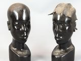 two statues of a man with a mohawk on each of them