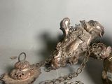 a silver object on the table next to a gold object