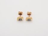 a pair of gold earrings with black and white diamonds