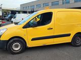 yellow van parked in a parking lot with other vehicles in the background