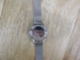 a watch that is sitting on a wooden table