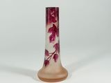 a pink glass vase with a floral design on it