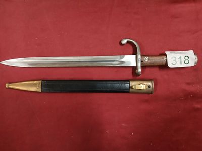 a close up of a knife and a sword on a red cloth