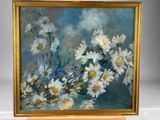 a painting of daisies in a gold frame on a white table