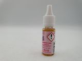 a close up of a bottle of liquid on a white surface
