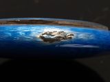 a close up of a blue bowl on a black surface
