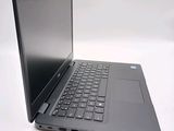 a laptop that is open on a white surface