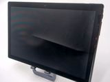 a tablet computer sitting on a stand on a white surface