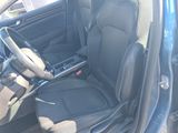 the interior of a car with the door open and the driver ' s seat down