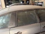 a car that is parked in a garage with its door open