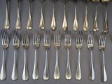 a lot of forks and spoons that are on the table