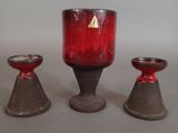 three red candles sitting next to each other on a table