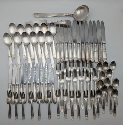 a lot of silver spoons and spoons on the table