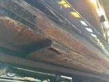 a close up of a truck with rust on the side of it