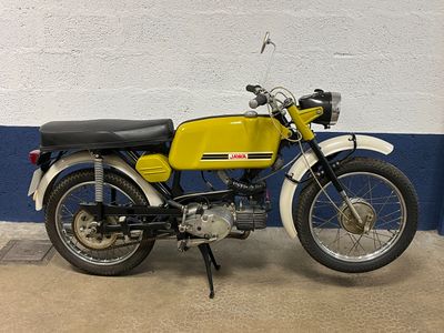a yellow and black motorcycle parked in a garage