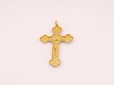 a gold cross pendant on a white background