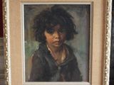 painting of a young boy with curly hair in a frame on a table