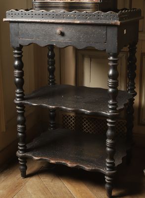 a black table with a basket of flowers on top of it