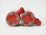 two red vases that are sitting on a table