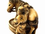 a small statue of a horse and a man sitting on a horse
