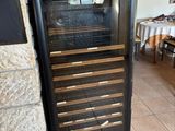 a wine cooler in the corner of a room