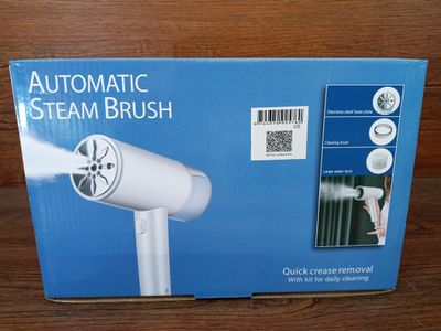 packaging of automatic steam brush in box on wooden surface