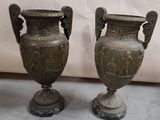 two vases that are sitting next to each other on the floor
