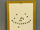 a framed picture of a yellow frame with buttons on it