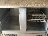 stainless steel counter top oven with two racks and a door open