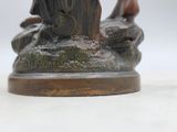 a statue of a man riding a horse on top of a rock
