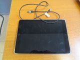 a tablet computer sitting on top of a wooden table